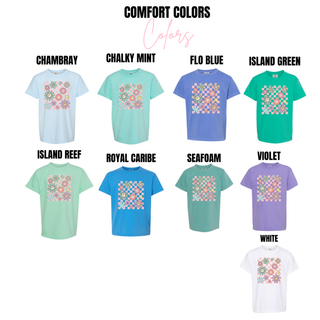Comfort Colors youth tees in chambray, chalky mint, flo blue, island green, island reef, royal caribe, seafoam, violet, and white with retro checkered smiley flower design

