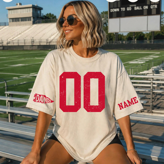 Sand oversized tee with distressed red custom number on the chest, a Dawgs pennant flag icon on one sleeve, and a personalized name on the other sleeve