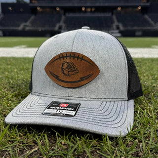 Rossville Dawgs football-shaped leather patch trucker hat at a stadium