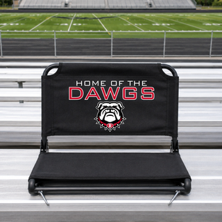 Black Rossville stadium seat on aluminum bleachers with Home of the Dawgs red text and bulldog mascot logo with R collar on backrest, football field background