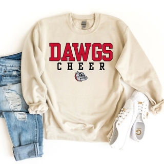 Cream Gildan crewneck game day top with bold red DAWGS varsity letters, black CHEER spaced text, bulldog mascot, styled with ripped jeans and white sneakers
