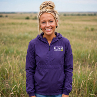 Woman wearing purple Royal Valley alumni living to serve packable jacket with ag program eagle emblem