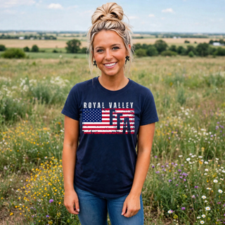 Woman wearing navy Royal Valley top with distressed American flag design in a wildflower field