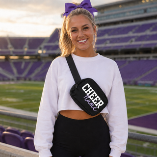 Cheerleader wearing a black Royal Valley Jr. Panthers Cheer personalized belt bag across her white top.