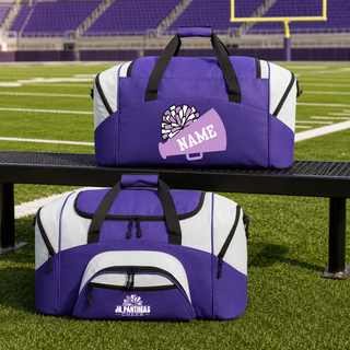 Royal Valley Jr. Panthers purple and white personalized cheer duffel bags displayed beside a football field