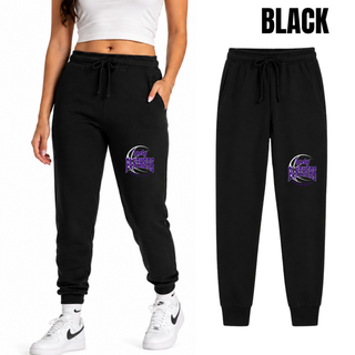 Woman wearing black fleece joggers with a Lady Panthers Basketball design on the front of the leg, with a flat lay of the joggers