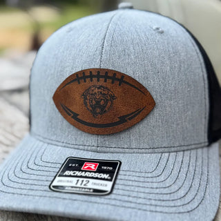 Close-up of Royal Valley Panthers leather football patch on grey and black trucker hat