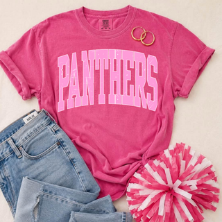 Royal Valley Panthers Pink Out distressed arch top in hot pink Comfort Colors flatlay with jeans, hoop earrings, and pink pom-pom
