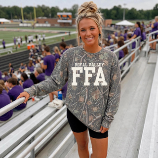 Model wearing Royal Valley varsity letter all-over camo long sleeve top
