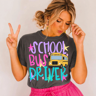 Woman wearing pepper grey School Bus Driver graphic tee with colorful lettering and school bus design

