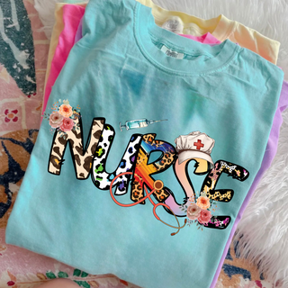Stack of Comfort Colors tees in chalky mint featuring Scrubs and Cheetah NURSE floral design
