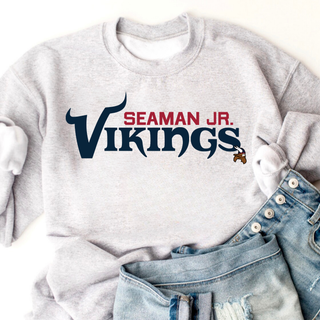 Ash grey crewneck flat lay with seaman jr. vikings signature football design featuring seaman jr. vikings wordmark
