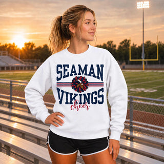 Woman wearing a white crewneck sweatshirt with the Seaman Vikings Cheer arched wordmark and pom graphic in navy and red