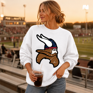 Woman wearing a white crewneck sweatshirt with the Seaman Vikings distressed mascot head icon in brown, navy, and red