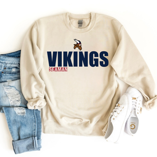 Sand Gildan crewneck with Seaman Vikings standout mascot logo graphic, styled with jeans and white shoes
