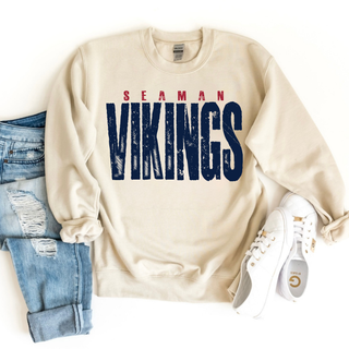 Sand Gildan crewneck sweatshirt with distressed Seaman Vikings vintage graphic, styled with jeans and white sneakers