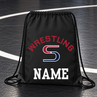 Black drawstring bag on a wrestling mat with red arched Wrestling lettering over a red and navy S logo and a white name placeholder below
