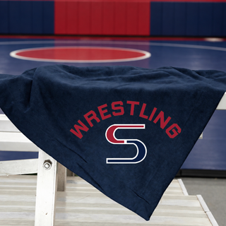 Navy stadium blanket draped over bleachers with red arched Wrestling lettering above a red and navy S logo
