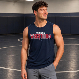 Smiling man in a wrestling room wearing a true navy sleeveless competitor tank with white Vikings above red Wrestling lettering and an S logo on the chest
