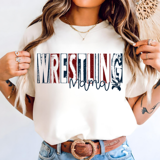 Woman wearing a white tee with distressed navy, red, and white Wrestling block lettering, navy script Mama, and a small Viking head across the chest
