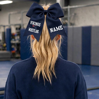 Navy grosgrain cheer bow worn in a ponytail, with white Vikings S logo Wrestling lettering on one tail and a name placeholder on the other