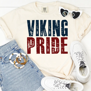 Ivory tee with distressed navy and crimson viking pride design, flat lay with sunglasses and denim shorts
