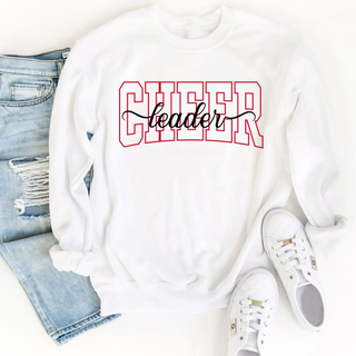 White shirt with CHEER leader spirit design. CHEER in red varsity outline letters with leader in black script. Flat lay with ripped jeans and white sneakers