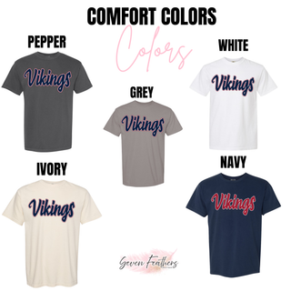 Comfort Colors shirts in Pepper, Grey, White, Ivory, and Navy. Each features Vikings retro script in navy with red and white outline. Navy shows red script with white outline