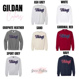Gildan tops in Ash Grey, White, Graphite Heather, Sand, Cardinal Red, Sport Grey, and Navy. Each features Vikings retro script in navy with red and white outline. Cardinal Red and Navy show alternate colorways