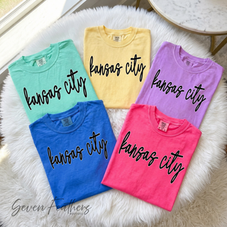 Folded kansas city script tops in island reef, butter, neon violet, crunchberry, and flo blue pastel colors

