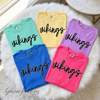 Folded pastel Comfort Colors tees with vikings script design in mint, yellow, lavender, pink, and blue

