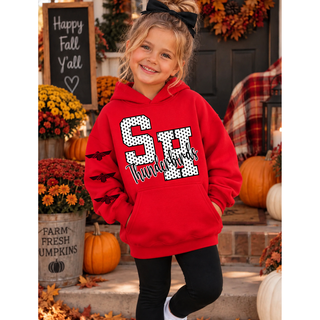 Girl in a red hoodie with a white polka dot SH outlined in black, black Thunderbirds script, and three black thunderbird logos down the sleeve