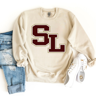 Sand crewneck sweatshirt with oversized bold SL block letter logo centered on front styled with jeans and sneakers
