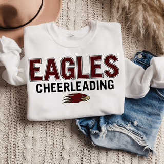 Folded white crewneck with EAGLES CHEERLEADING bold block text and Eagles mascot logo front view flat lay
