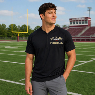 Man wearing black Silver Lake Eagles Football Classic repeat half-zip short sleeve jacket on football field