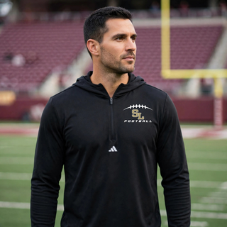 Male model wearing Silver Lake Eagles Football Kickoff black Adidas quarter-zip hooded pullover on football field

