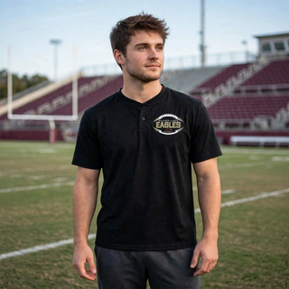 Man wearing black Silver Lake Eagles Football Stitchmark two button performance tee at football stadium
