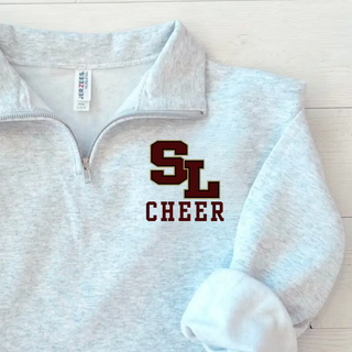 Ash grey quarter zip with staggered SL block letter logo and CHEER text on left chest close up front view
