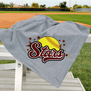 Grey stadium blanket draped over white bleachers at a softball field with large maroon and gold SL Stars softball logo featuring yellow softball maroon script Stars and maroon star burst DTF print with softball field visible in background