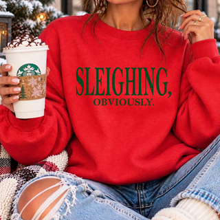 Sleighing Obviously Green Top - "Sleighing, obviously." in bold green lettering on a red Bella Canvas crewneck sweatshirt