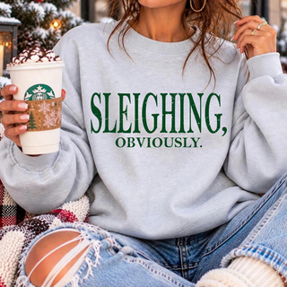 Sleighing Obviously Green Top - "Sleighing, obviously." in bold green lettering on a heather grey Bella Canvas crewneck sweatshirt