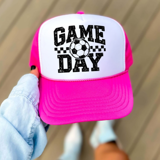 Soccer Game Day Checkered Trucker Hat in neon pink and white, worn, featuring distressed Game Day text, checkered stripe, and soccer ball graphic