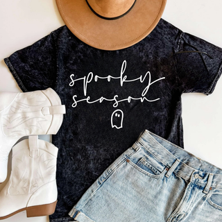 Black mineral wash Spooky Season top with script lettering and ghost graphic styled with boots and shorts