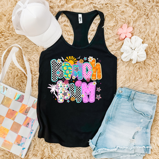 black Next Level racerback tank with colorful beach bum patterned letter design, styled with denim shorts and white hat
