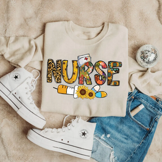 Sand crewneck with NURSE leopard sunflower floral letters, nurse hat, syringe, and pills, adult unisex