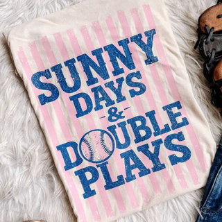 Ivory tee laid flat with SUNNY DAYS and DOUBLE PLAYS baseball pink stripe distressed graphic design