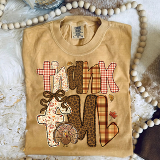Thankful Patchwork Turkey Tee - front view, turkey graphic made of leopard, plaid, and gingham patchwork with THANKFUL wordmark on a Comfort Colors tee