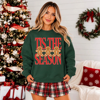 Green crewneck sweatshirt with red Tis the Season lettering and three gingerbread people.