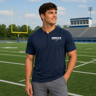 Model wearing a True Navy Topeka Saints Full Speed Football Short Sleeve Half-Zip Jacket on a football field