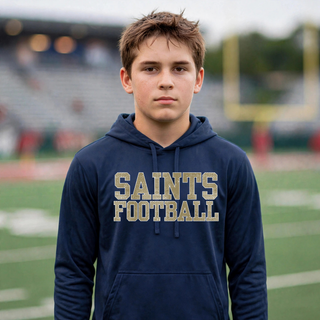 Deep navy Topeka Saints textured varsity football performance fleece hoodie modeled on a football field